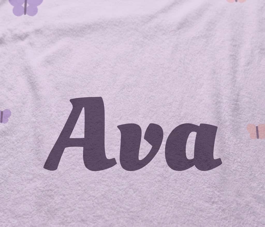 Detail view of the full plum Ava script on soft lavender flannel