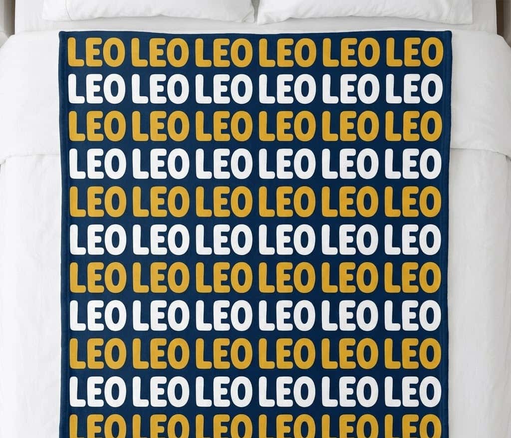 Kids name repeat blanket with Leo in mustard and white rows on a bed