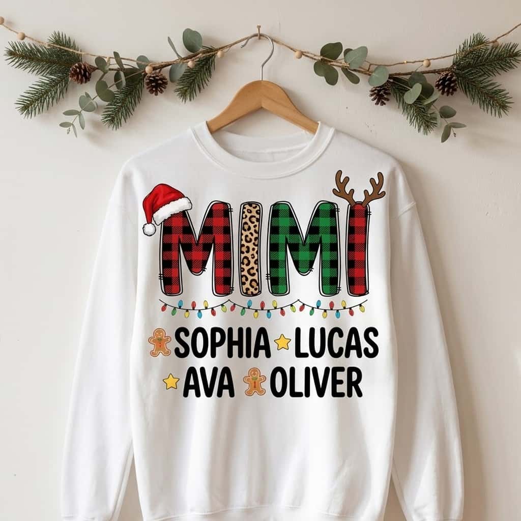 Mimi Christmas crewneck with plaid letters on a wooden hanger under pine garland