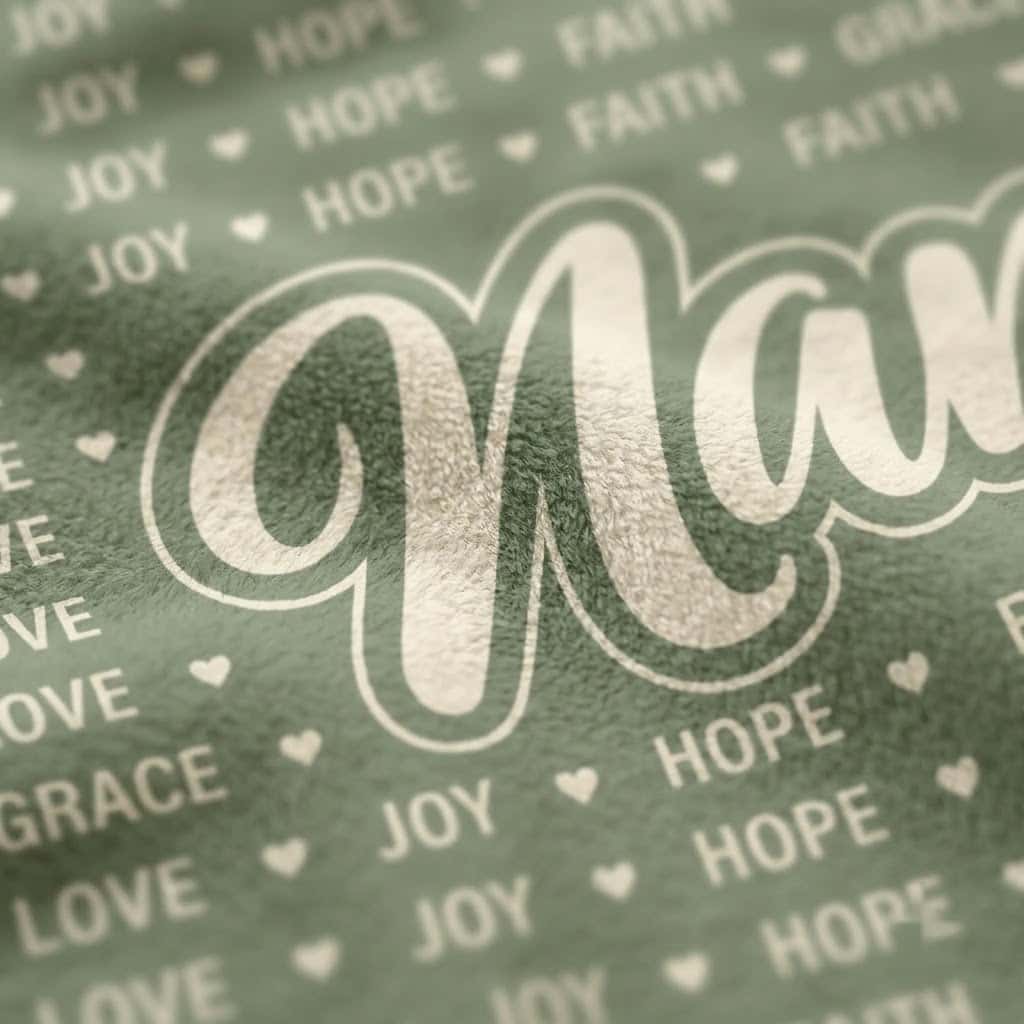 Close-up of Nana script and repeating word pattern on sage flannel