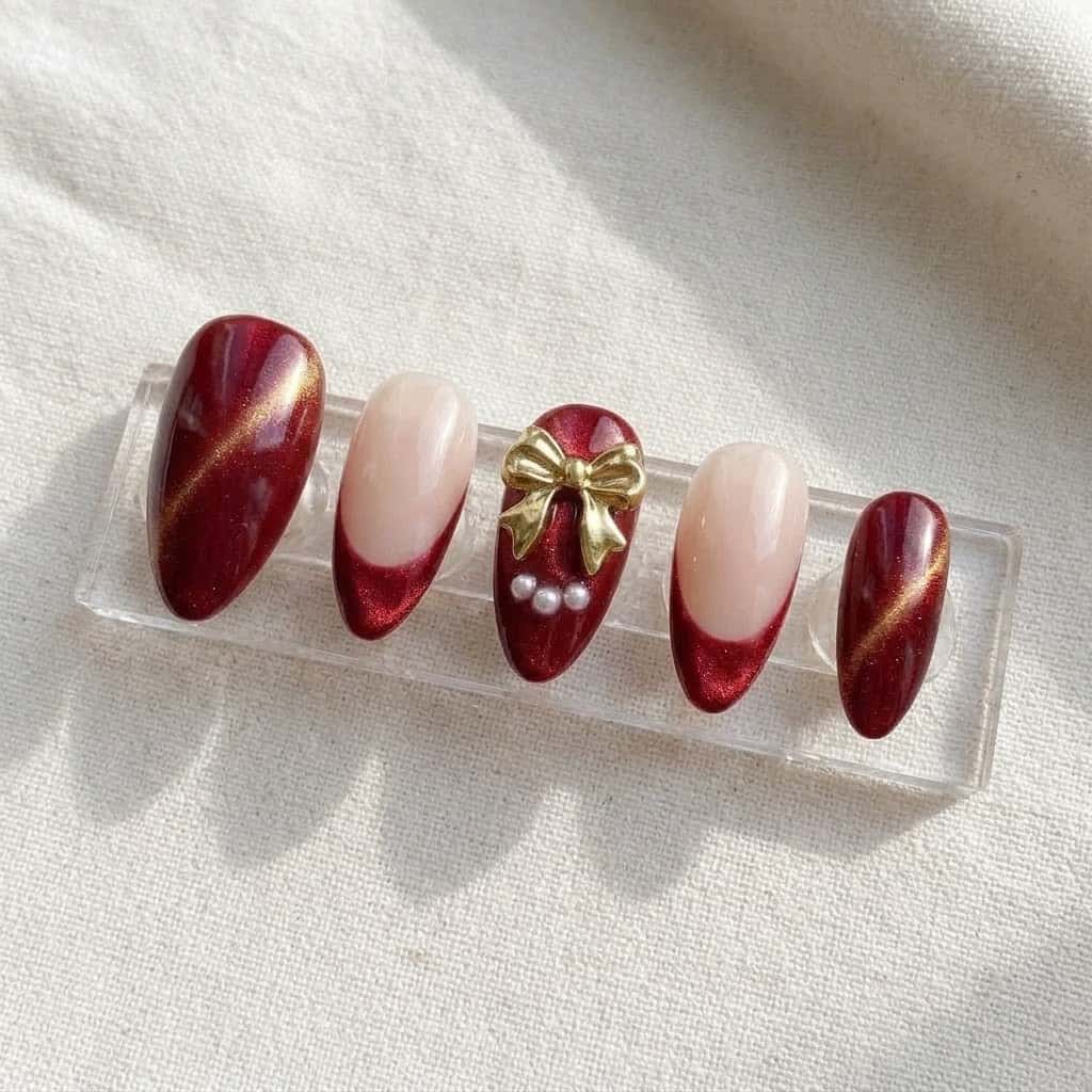 Five red cat eye press on nails on a clear acrylic stand