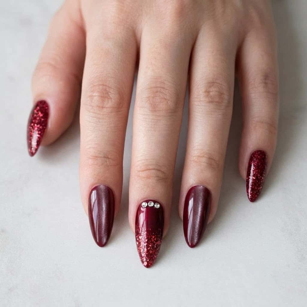 Hand wearing ruby glitter and red cat eye almond press on nails