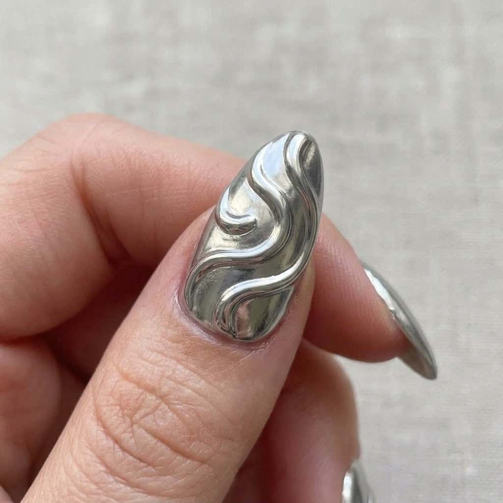 Close-up of the hero silver chrome nail with 3D detail
