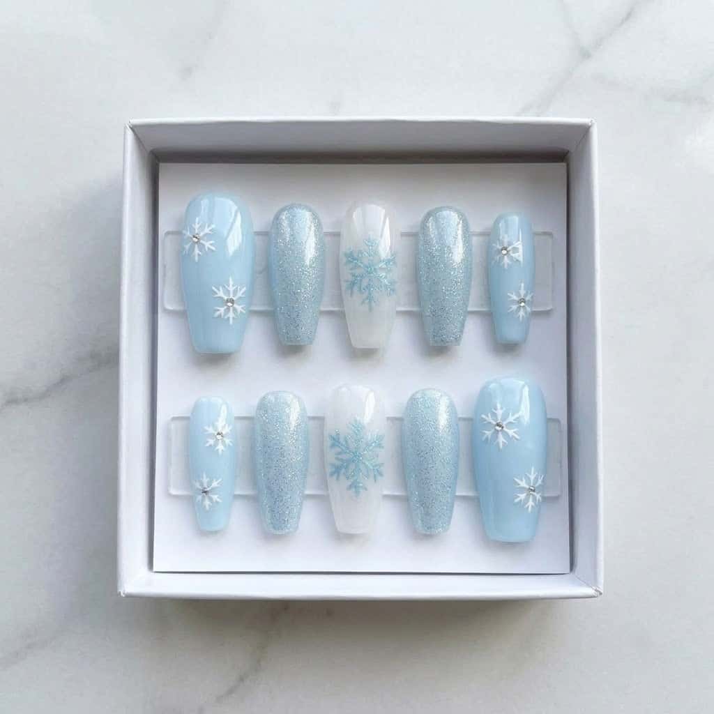 Icy blue snowflake press on nails set in a white gift box