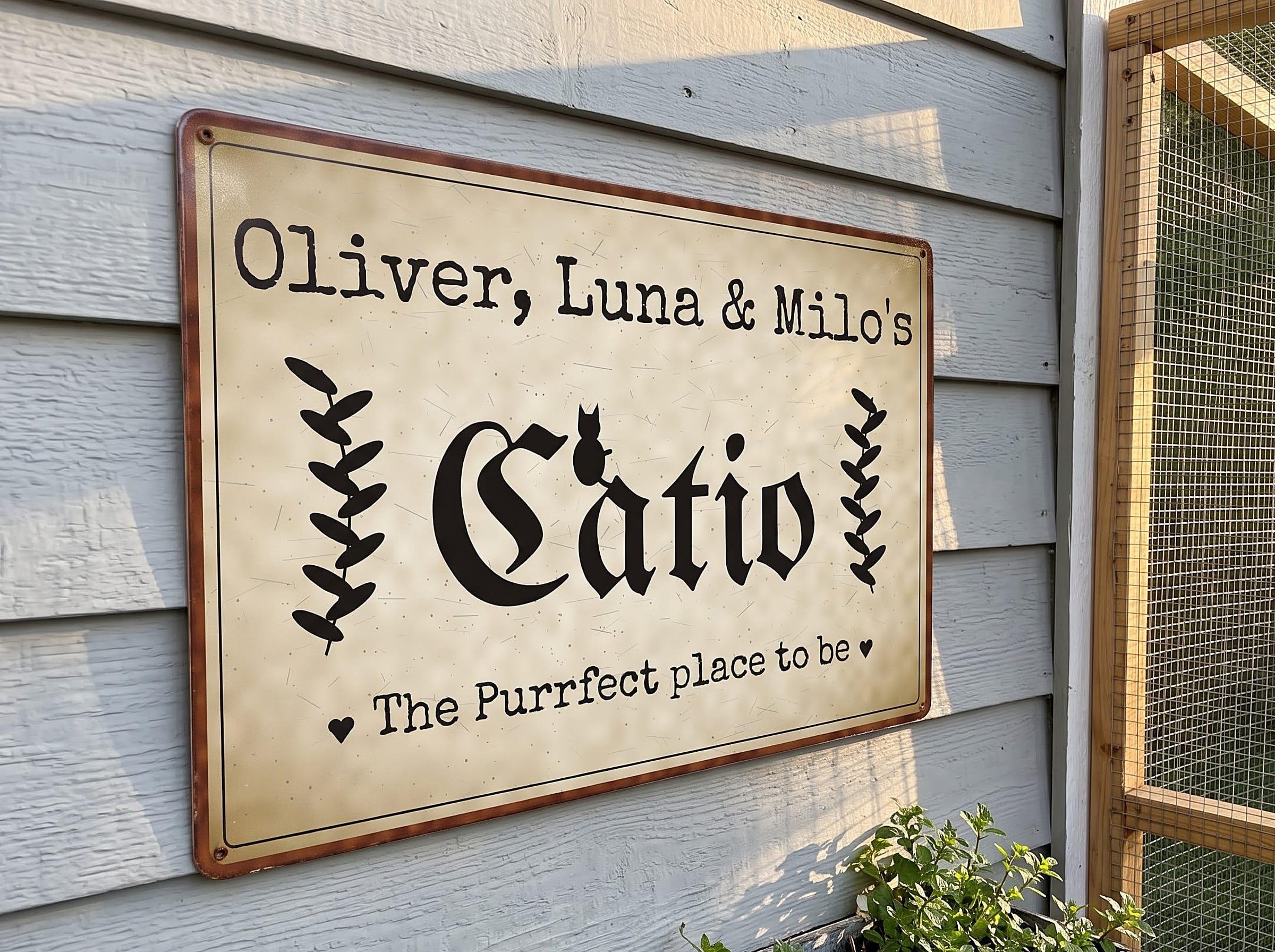 8x12 catio metal sign on gray siding beside a backyard cat enclosure