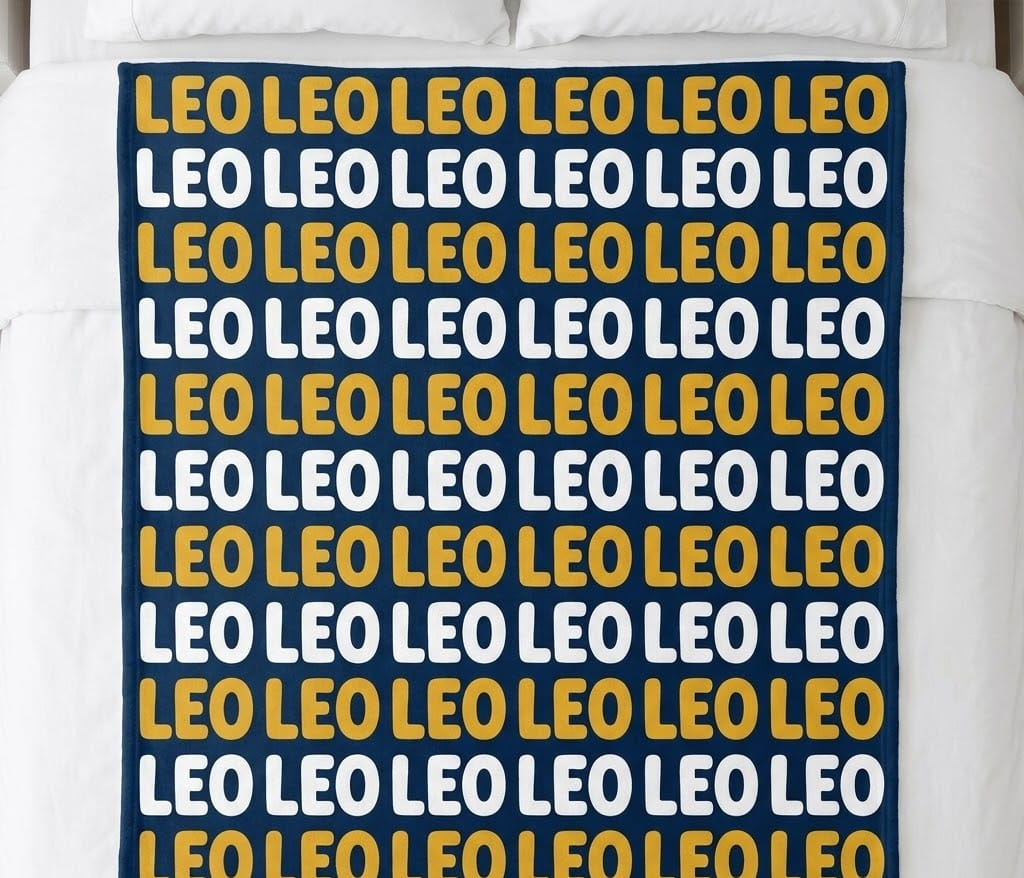 Kids name repeat blanket with Leo in mustard and white rows on a bed