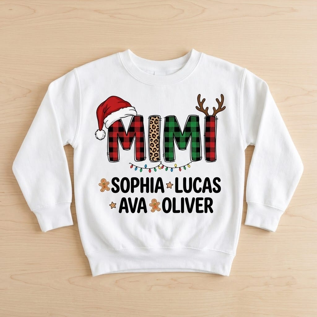 White Mimi Christmas sweatshirt laid flat on light wood with four grandkids names