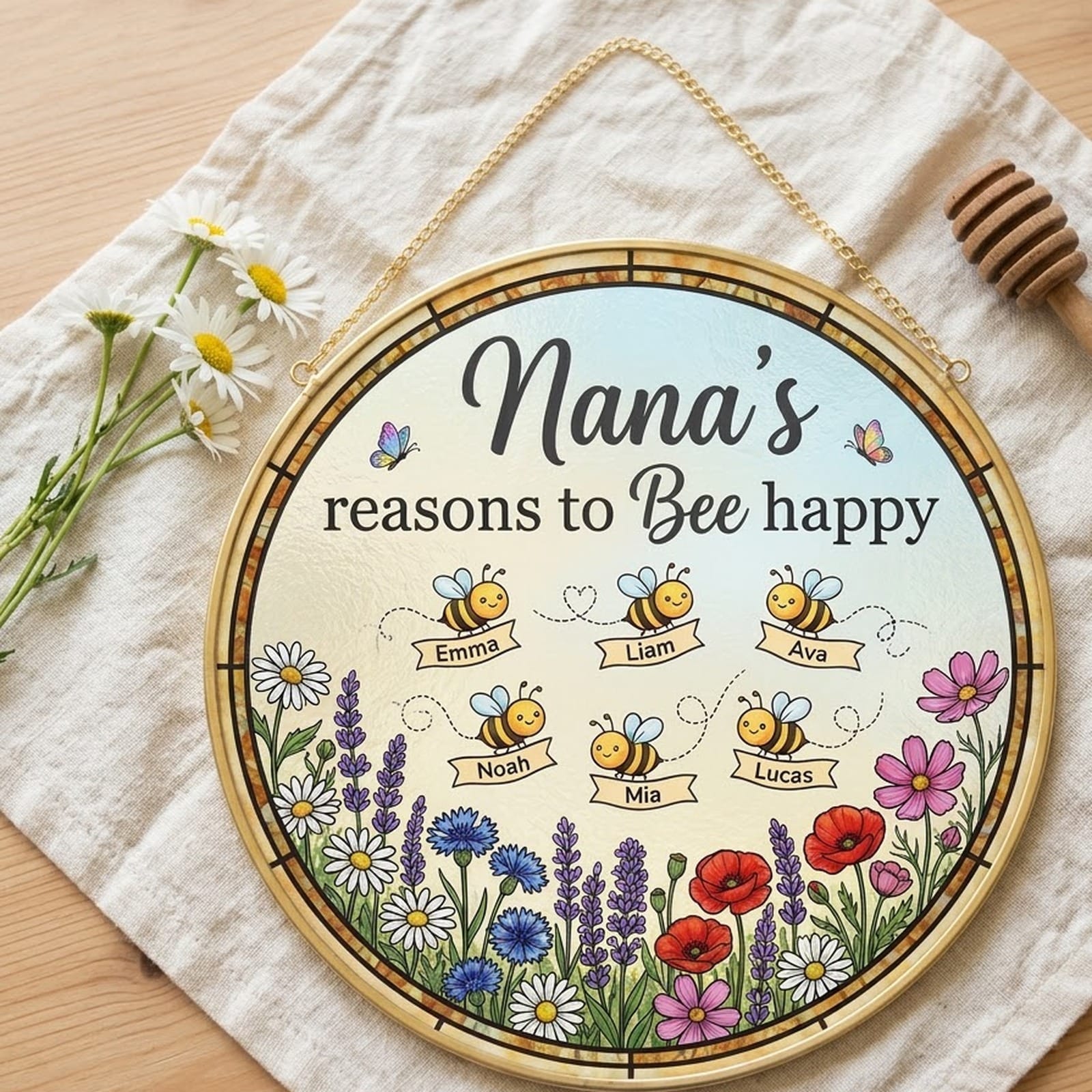 Nana suncatcher lying on linen beside daisies