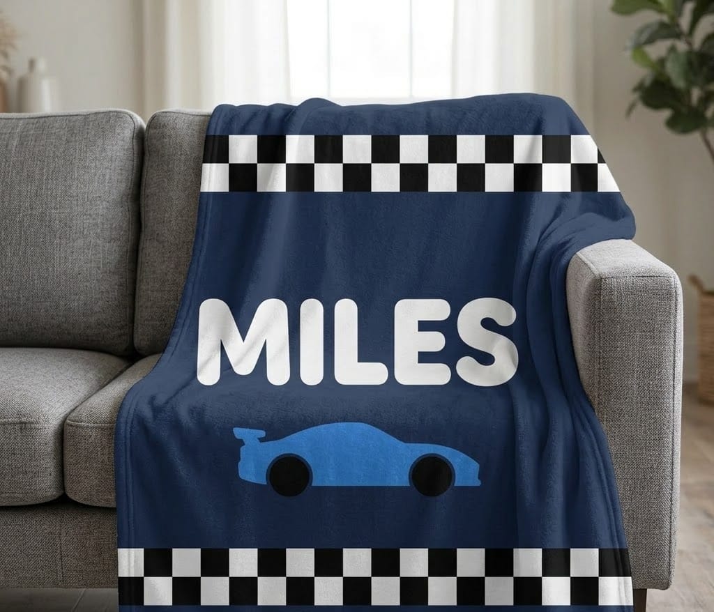 MILES race car name blanket draped over a gray sofa arm