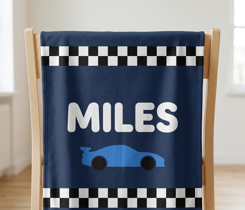 Navy checkered race car name blanket hung over a wooden chair back